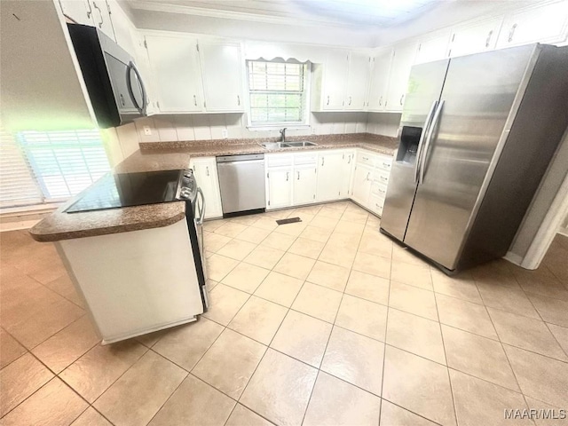 2 Rolling Hills Cir, Camden, AL 36726 - kitchen with appliances with stainless steel finishes, light tile patterned floors, white cabinets, and ornamental molding