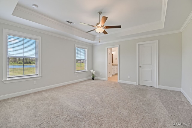 97 Abbington Blvd, Pike Road, AL 36064 - unfurnished bedroom featuring a raised ceiling, crown molding, multiple windows, light carpet, and ensuite bath