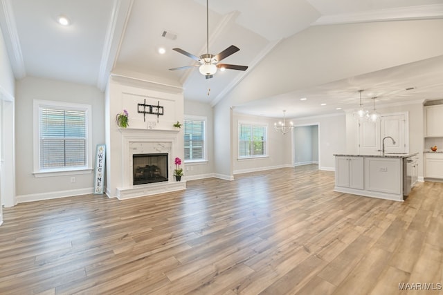 97 Abbington Blvd, Pike Road, AL 36064 - unfurnished living room featuring a chandelier, a ceiling fan, lofted ceiling, a premium fireplace, and crown molding
