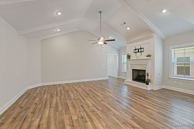 97 Abbington Blvd, Pike Road, AL 36064 - unfurnished living room with a ceiling fan, wood finished floors, vaulted ceiling, a fireplace, and crown molding