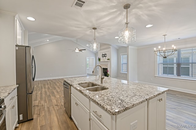 97 Abbington Blvd, Pike Road, AL 36064 - kitchen featuring stainless steel appliances, ceiling fan, white cabinets, wood finished floors, and a fireplace