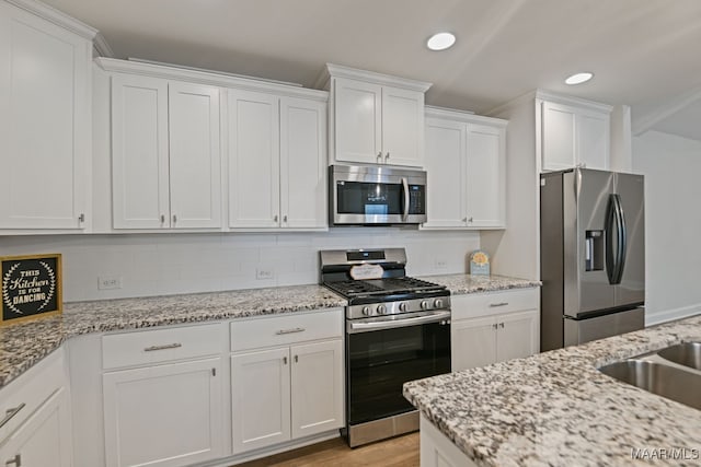 97 Abbington Blvd, Pike Road, AL 36064 - kitchen featuring appliances with stainless steel finishes, white cabinetry, recessed lighting, backsplash, and light stone counters