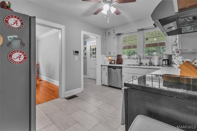 17 Calhoun Rd, Montgomery, AL 36109 - kitchen featuring range hood, appliances with stainless steel finishes, white cabinets, ceiling fan, and light countertops