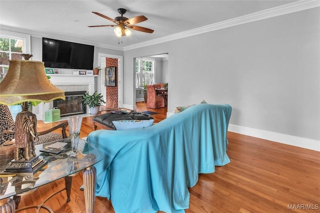 17 Calhoun Rd, Montgomery, AL 36109 - living area featuring crown molding, ceiling fan, wood finished floors, and a fireplace with flush hearth