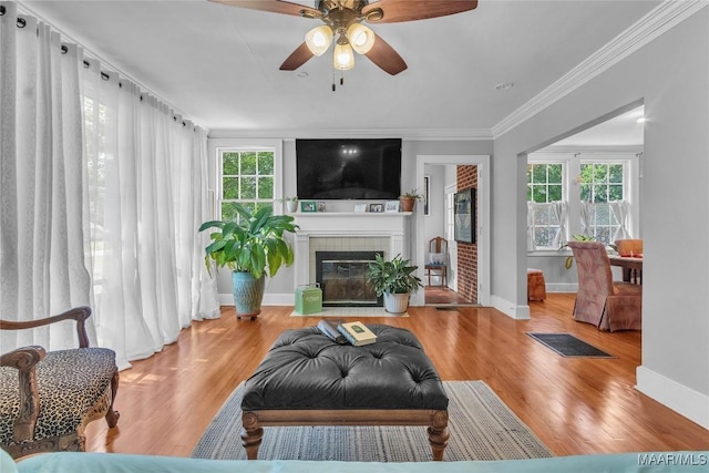 17 Calhoun Rd, Montgomery, AL 36109 - living room with ceiling fan, ornamental molding, wood finished floors, and a fireplace with flush hearth