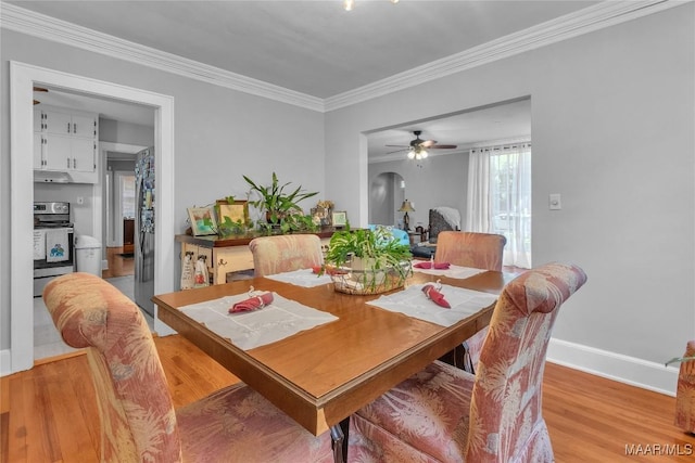 17 Calhoun Rd, Montgomery, AL 36109 - dining room with light wood-type flooring, crown molding, arched walkways, and ceiling fan