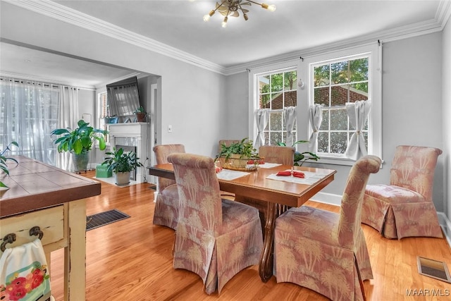 17 Calhoun Rd, Montgomery, AL 36109 - dining room with light wood-style floors, ornamental molding, and a fireplace