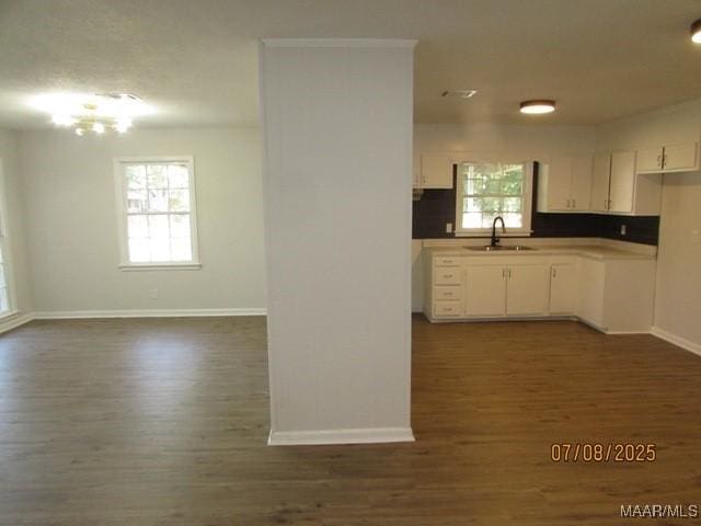 4225 Sunshine Dr, Montgomery, AL 36116 - kitchen with dark wood-style flooring, white cabinets, and a chandelier