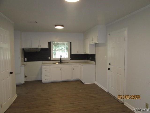 4225 Sunshine Dr, Montgomery, AL 36116 - kitchen featuring ornamental molding, dark wood-type flooring, white cabinetry, and exhaust hood