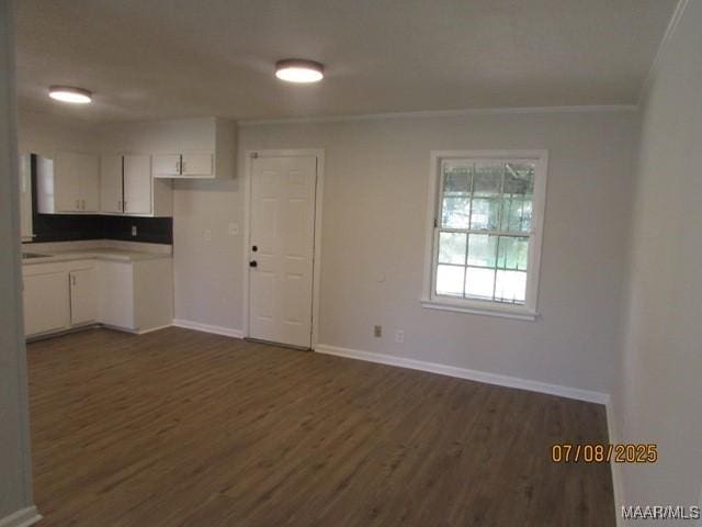 4225 Sunshine Dr, Montgomery, AL 36116 - unfurnished living room with ornamental molding and dark wood finished floors
