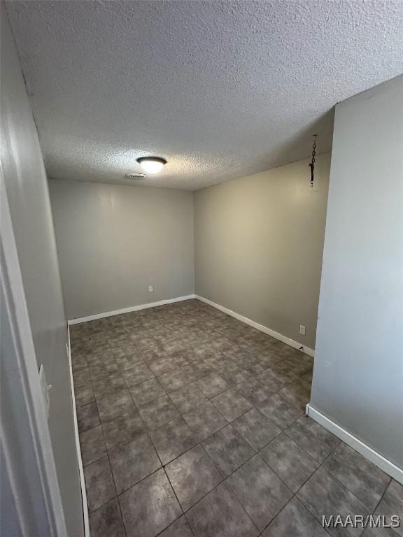 3902 Wesley Dr, Montgomery, AL 36111 - unfurnished room featuring a textured ceiling and baseboards