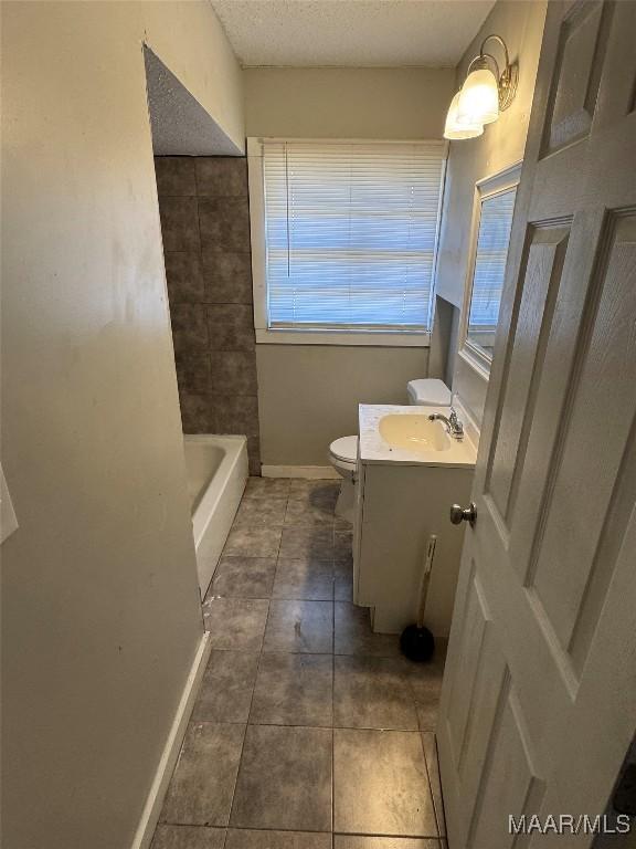 3902 Wesley Dr, Montgomery, AL 36111 - bathroom featuring vanity, a bath, tile patterned flooring, and a textured ceiling