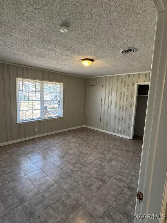 3902 Wesley Dr, Montgomery, AL 36111 - unfurnished room with a smoke detector, a textured ceiling, and tile patterned flooring