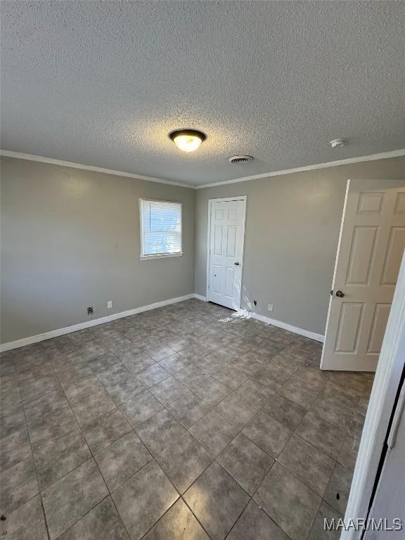 3902 Wesley Dr, Montgomery, AL 36111 - spare room with crown molding and a textured ceiling