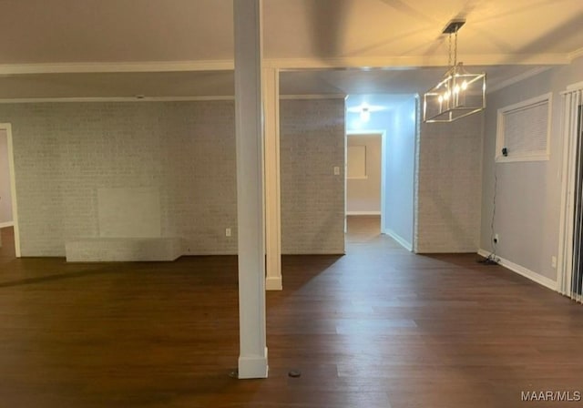 123 Hobbie Dr, Montgomery, AL 36105 - basement featuring dark wood-type flooring, a chandelier, crown molding, and brick wall