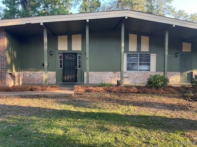 123 Hobbie Dr, Montgomery, AL 36105 - entrance to property featuring stone siding, a yard, and brick siding