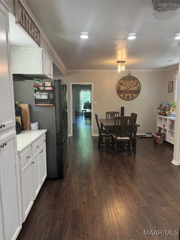 3549 Audubon Rd, Montgomery, AL 36111 - kitchen with dark wood-style floors, white cabinets, crown molding, light countertops, and recessed lighting