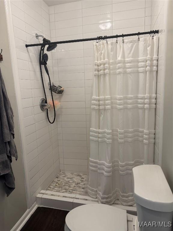 3549 Audubon Rd, Montgomery, AL 36111 - full bath with tiled shower and wood finished floors
