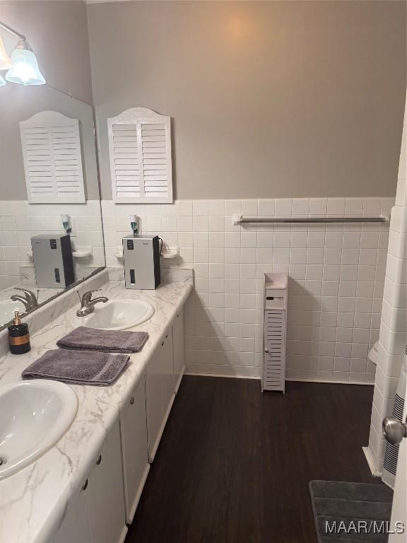 3549 Audubon Rd, Montgomery, AL 36111 - full bath with tile walls, double vanity, wood finished floors, and wainscoting
