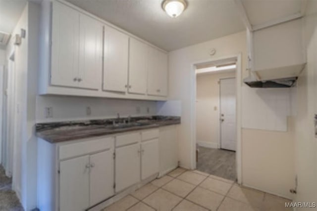 4230 Knollgate Rd, Montgomery, AL 36116 - kitchen featuring dark countertops and white cabinetry