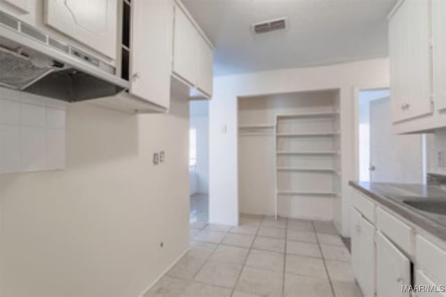 4230 Knollgate Rd, Montgomery, AL 36116 - kitchen featuring white cabinetry and light tile patterned flooring