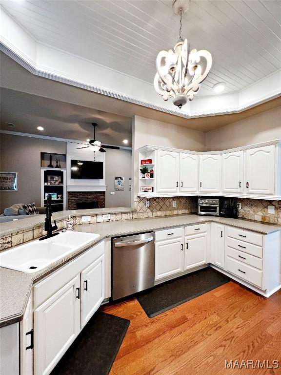 267 River Birch Cir, Wetumpka, AL 36093 - kitchen with stainless steel dishwasher, dark wood-style flooring, a chandelier, ceiling fan, and backsplash