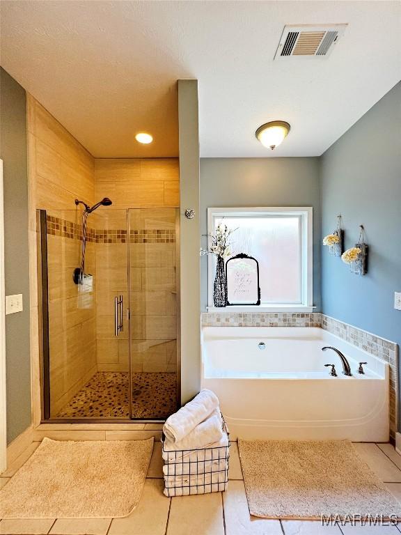 267 River Birch Cir, Wetumpka, AL 36093 - full bathroom with tile patterned floors, a garden tub, and a stall shower