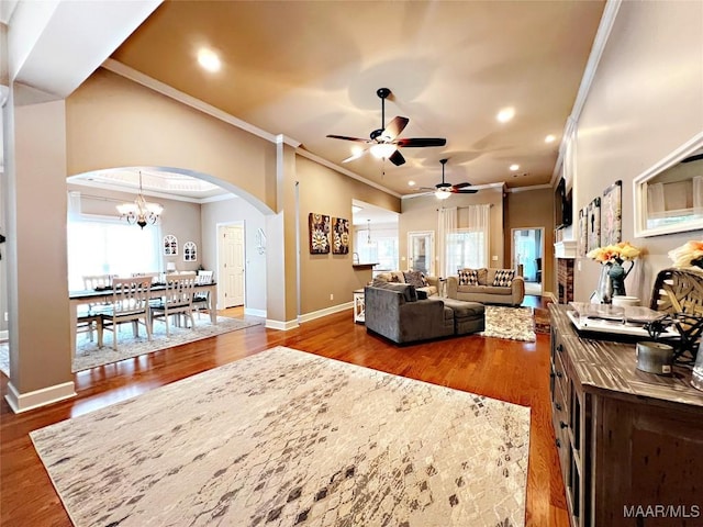 267 River Birch Cir, Wetumpka, AL 36093 - living room featuring crown molding, arched walkways, plenty of natural light, a ceiling fan, and wood finished floors
