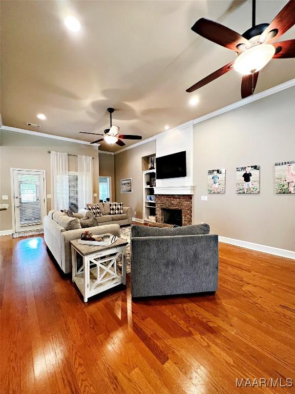 267 River Birch Cir, Wetumpka, AL 36093 - living room featuring a ceiling fan, ornamental molding, wood finished floors, a brick fireplace, and recessed lighting