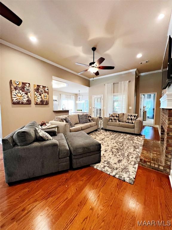 267 River Birch Cir, Wetumpka, AL 36093 - living room featuring ceiling fan, ornamental molding, wood finished floors, and a fireplace