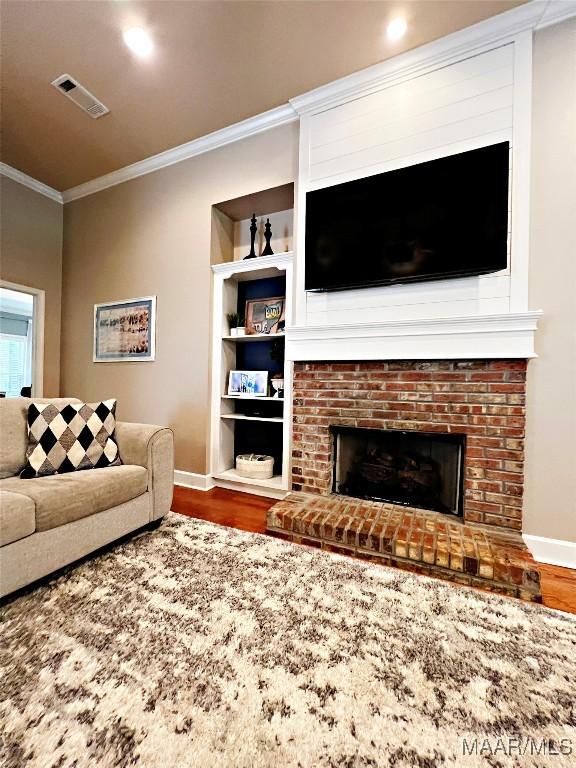 267 River Birch Cir, Wetumpka, AL 36093 - living room with wood finished floors, crown molding, and a fireplace