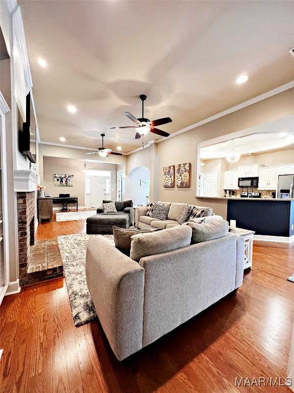 267 River Birch Cir, Wetumpka, AL 36093 - living area featuring a ceiling fan, a brick fireplace, ornamental molding, wood finished floors, and recessed lighting