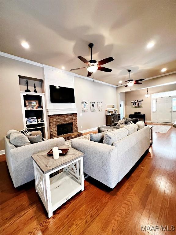 267 River Birch Cir, Wetumpka, AL 36093 - living area featuring a brick fireplace, ornamental molding, ceiling fan, dark wood finished floors, and recessed lighting