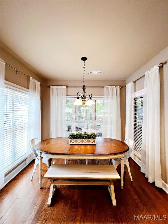 267 River Birch Cir, Wetumpka, AL 36093 - dining space featuring healthy amount of natural light, a chandelier, wood finished floors, and baseboard heating