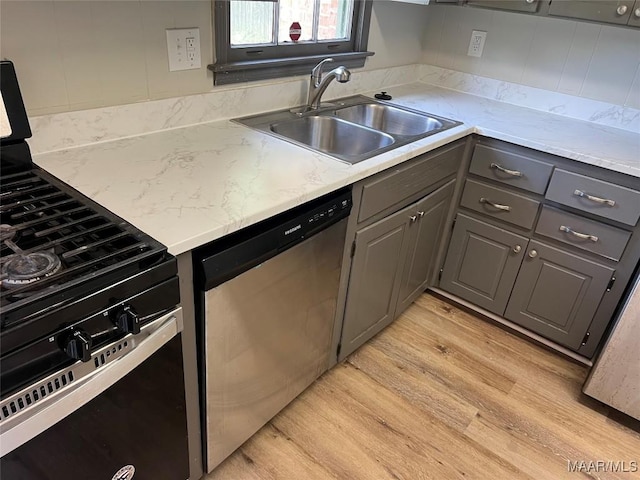 341 Sultan Ct, Montgomery, AL 36117 - kitchen with range with gas cooktop, dishwasher, gray cabinetry, light wood finished floors, and light countertops