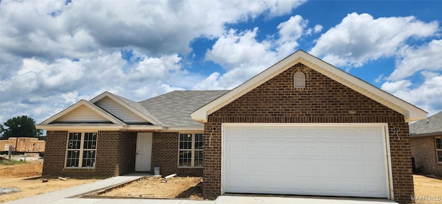 67 Gaines Ct, Wetumpka, AL 36092 - ranch-style home featuring brick siding, an attached garage, concrete driveway, and roof with shingles