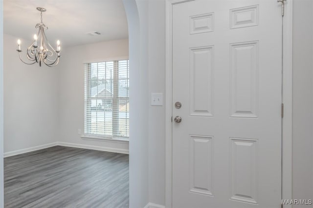 67 Gaines Ct, Wetumpka, AL 36092 - entrance foyer featuring arched walkways, a chandelier, and dark wood-style flooring