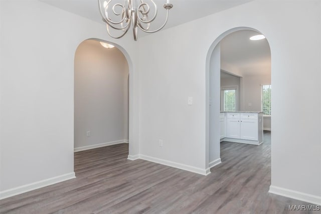 67 Gaines Ct, Wetumpka, AL 36092 - spare room with wood finished floors, a chandelier, and arched walkways