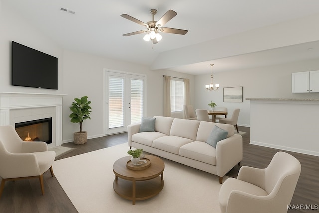 67 Gaines Ct, Wetumpka, AL 36092 - living area featuring dark wood finished floors, ceiling fan, a fireplace with flush hearth, a chandelier, and vaulted ceiling