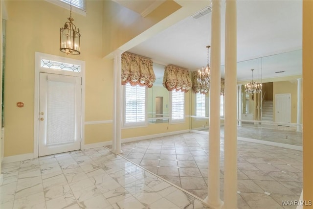 1609 Wentworth Dr, Montgomery, AL 36106 - entrance foyer with a chandelier, ornate columns, and marble look tiles