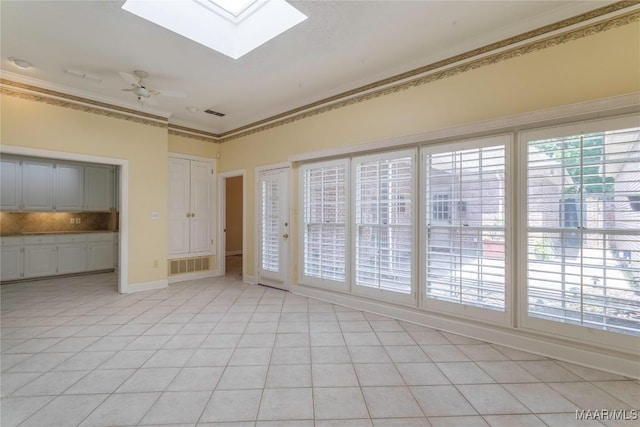 1609 Wentworth Dr, Montgomery, AL 36106 - empty room featuring a skylight, crown molding, light tile patterned flooring, and ceiling fan