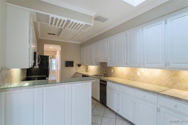 1609 Wentworth Dr, Montgomery, AL 36106 - kitchen with white cabinetry, crown molding, light tile patterned floors, backsplash, and light countertops