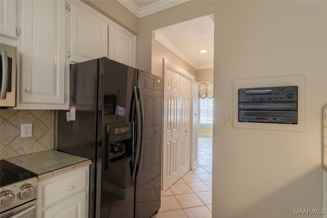 1609 Wentworth Dr, Montgomery, AL 36106 - kitchen with black fridge with ice dispenser, crown molding, light tile patterned floors, electric range oven, and tasteful backsplash