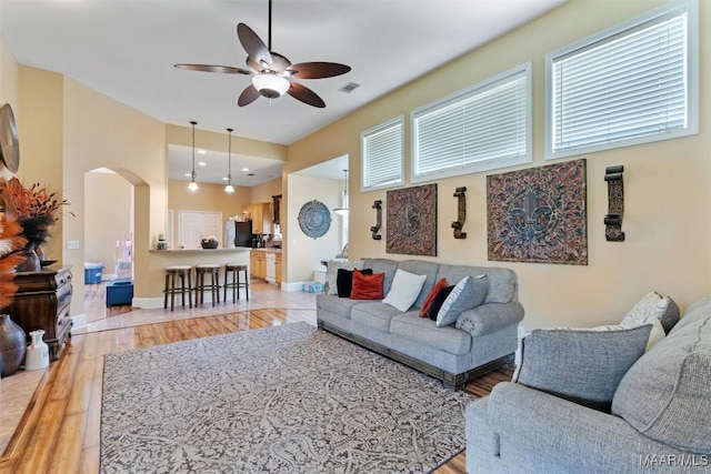 8531 Pipit Ct, Montgomery, AL 36117 - living room featuring ceiling fan, light wood-type flooring, and arched walkways