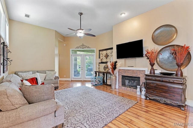 8531 Pipit Ct, Montgomery, AL 36117 - living room featuring wood finished floors, a ceiling fan, and a tiled fireplace