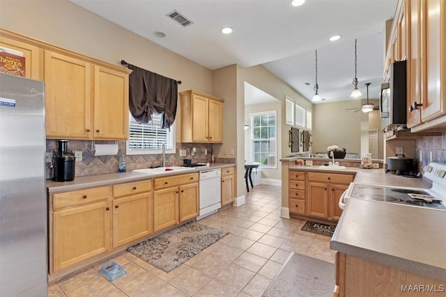 8531 Pipit Ct, Montgomery, AL 36117 - kitchen featuring appliances with stainless steel finishes, light brown cabinets, tasteful backsplash, a ceiling fan, and light tile patterned flooring