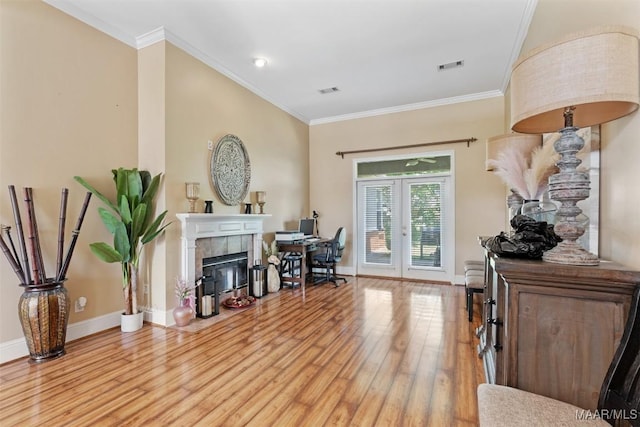 8531 Pipit Ct, Montgomery, AL 36117 - foyer entrance featuring french doors, light wood-type flooring, ornamental molding, and a tile fireplace