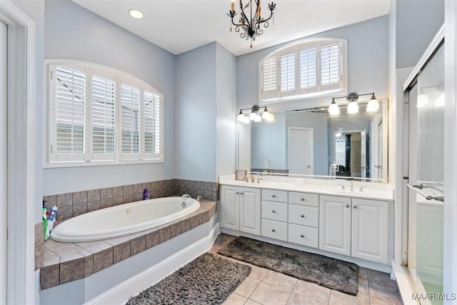 8531 Pipit Ct, Montgomery, AL 36117 - bathroom with double vanity, a bath, tile patterned flooring, and a chandelier