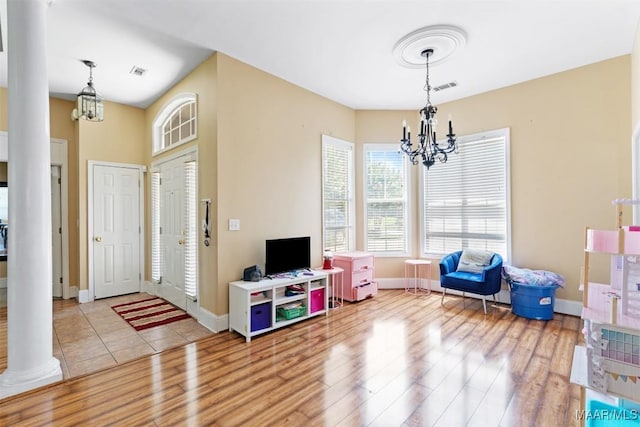 8531 Pipit Ct, Montgomery, AL 36117 - rec room with a chandelier, decorative columns, and wood finished floors