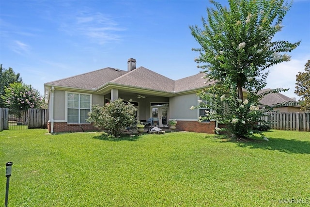 8531 Pipit Ct, Montgomery, AL 36117 - back of house featuring ceiling fan, a fenced backyard, stucco siding, and brick siding